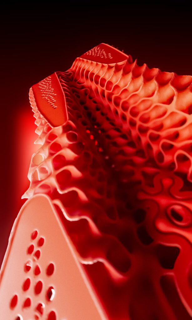 Macro de la mediasuela impresa en 3D de la Kiprun KipNext 3D, con estructura roja de celosía y zonas abiertas de amortiguación.